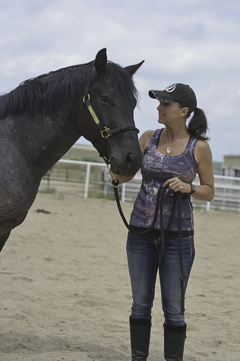 Candice Ensign standing with a horse